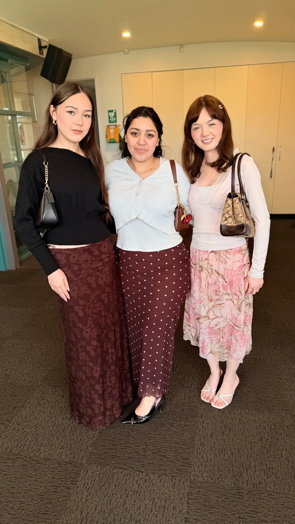 Tres jóvenes juntas en una reunión de la iglesia
